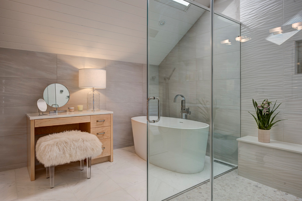 Photo of a mid-sized contemporary master bathroom in New York with flat-panel cabinets, light wood cabinets, a freestanding tub, white tile, porcelain tile, a corner shower and grey walls.