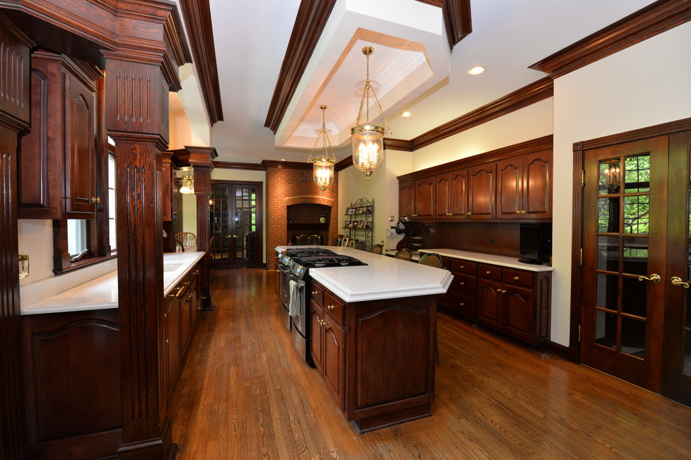 Example of a mid-sized transitional medium tone wood floor open concept kitchen design in Chicago with an integrated sink, beaded inset cabinets, dark wood cabinets, quartz countertops and an island