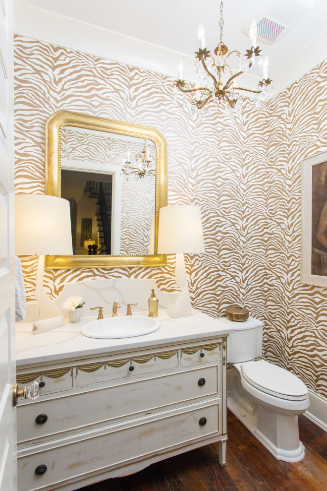 This is an example of a mid-sized traditional powder room in Other with furniture-like cabinets, a drop-in sink, engineered quartz benchtops, white benchtops, a freestanding vanity and wallpaper.