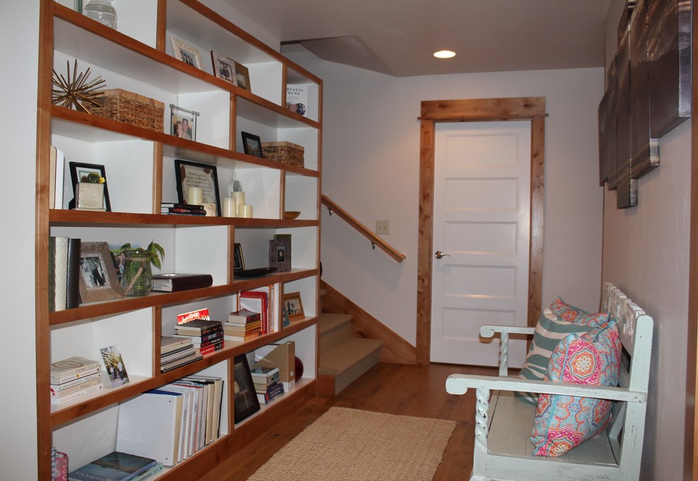 Example of a mid-sized transitional medium tone wood floor and brown floor hallway design with white walls