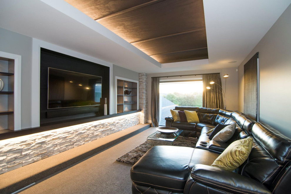 Large modern enclosed home theatre in Hamilton with carpet and a built-in media wall.