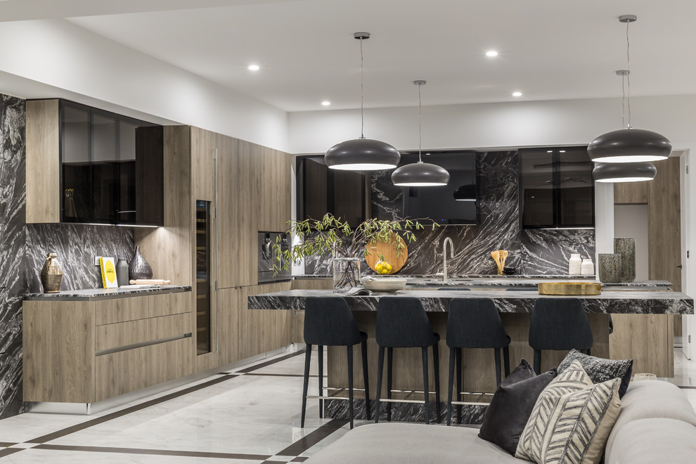 Inspiration for a contemporary l-shaped open plan kitchen in Gold Coast - Tweed with an undermount sink, flat-panel cabinets, medium wood cabinets, grey splashback, panelled appliances, multiple islands, white floor and grey benchtop.