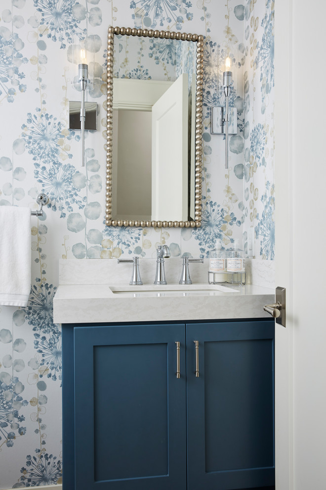 Mid-sized traditional powder room in Minneapolis with recessed-panel cabinets, blue cabinets, a two-piece toilet, blue walls, an undermount sink, quartzite benchtops and white benchtops.