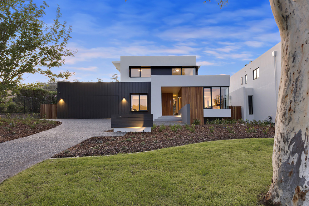 Large contemporary two-storey multi-coloured house exterior in Canberra - Queanbeyan with a flat roof and a metal roof.