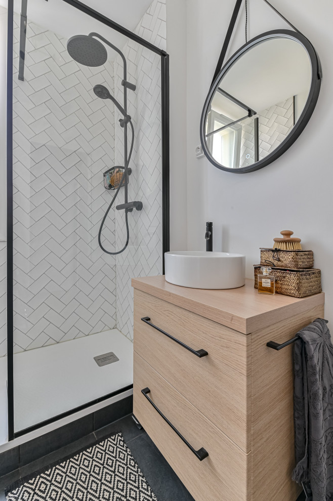 Photo of a small scandinavian 3/4 bathroom in Paris with beaded inset cabinets, light wood cabinets, a curbless shower, a wall-mount toilet, white tile, terra-cotta tile, white walls, terra-cotta floors, a wall-mount sink, grey floor, a single vanity and a floating vanity.
