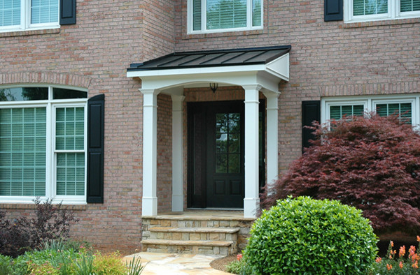 This is an example of a small traditional front yard verandah in Atlanta with a roof extension.
