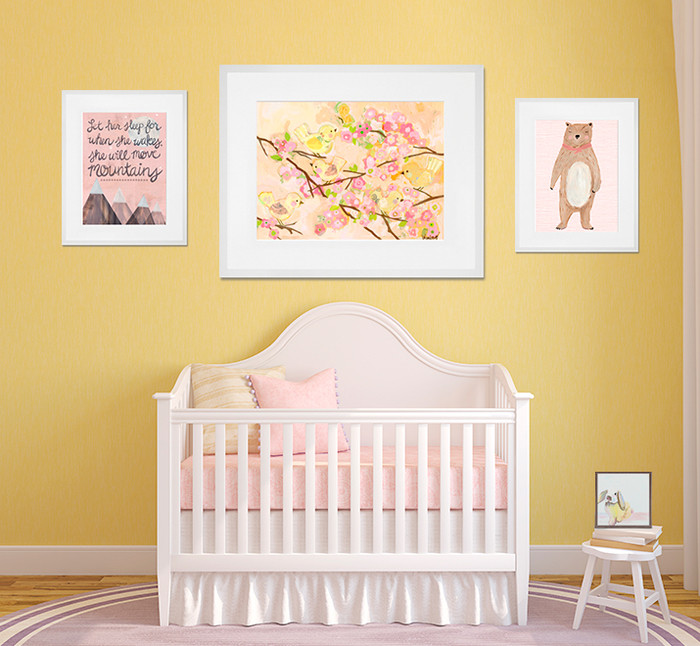 Photo of a modern nursery for girls in San Diego with yellow walls, medium hardwood floors and brown floor.