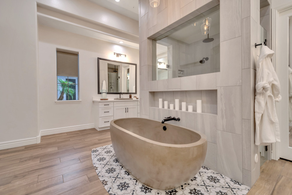 Huge urban master porcelain tile, brown floor and double-sink bathroom photo in Phoenix with flat-panel cabinets, white cabinets, white walls, a drop-in sink, quartz countertops, a hinged shower door, white countertops and a built-in vanity