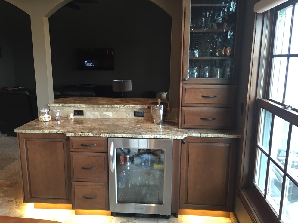 Inspiration for a large timeless u-shaped porcelain tile eat-in kitchen remodel in Cedar Rapids with a double-bowl sink, raised-panel cabinets, dark wood cabinets, granite countertops, beige backsplash, stainless steel appliances and a peninsula