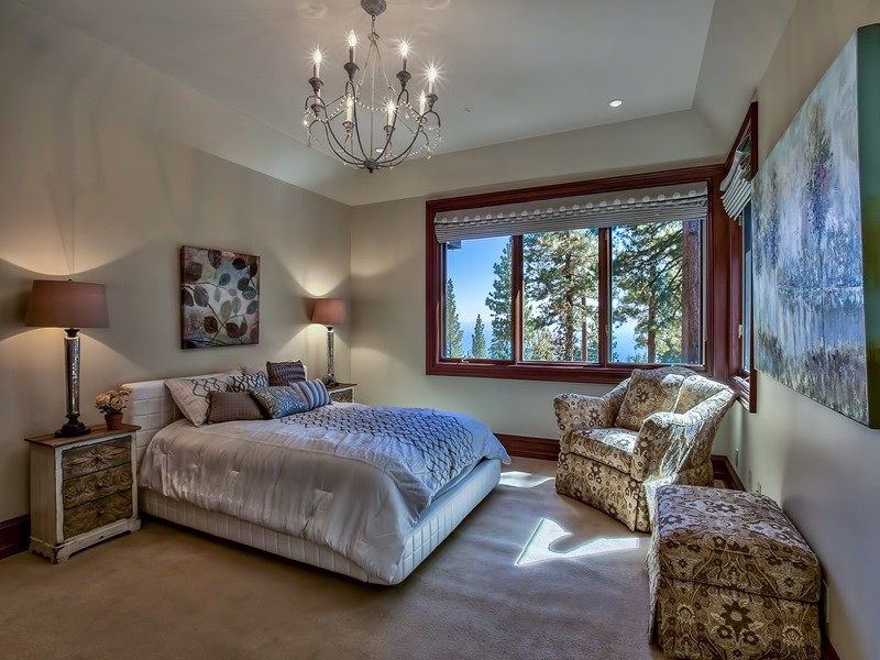 Mid-sized country guest bedroom in Sacramento with beige walls and carpet.