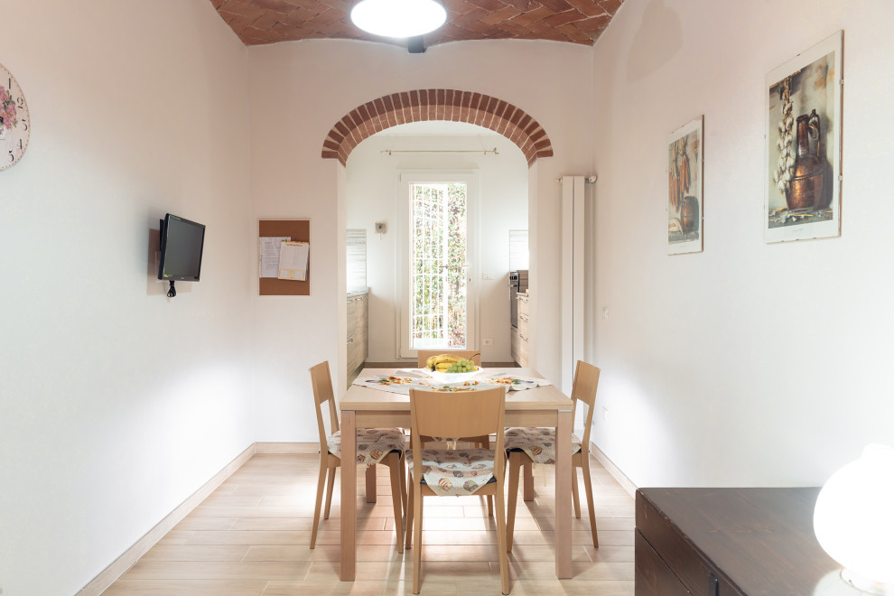 Inspiration for a mid-sized contemporary separate dining room in Florence with white walls, porcelain floors, beige floor and vaulted.