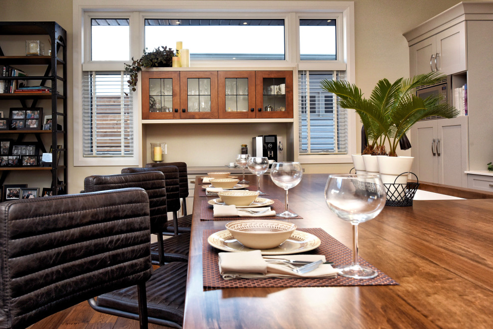 Kitchen - mid-sized craftsman medium tone wood floor kitchen idea in Toronto with a double-bowl sink, recessed-panel cabinets, gray cabinets, solid surface countertops, multicolored backsplash, porcelain backsplash, stainless steel appliances, an island and white countertops