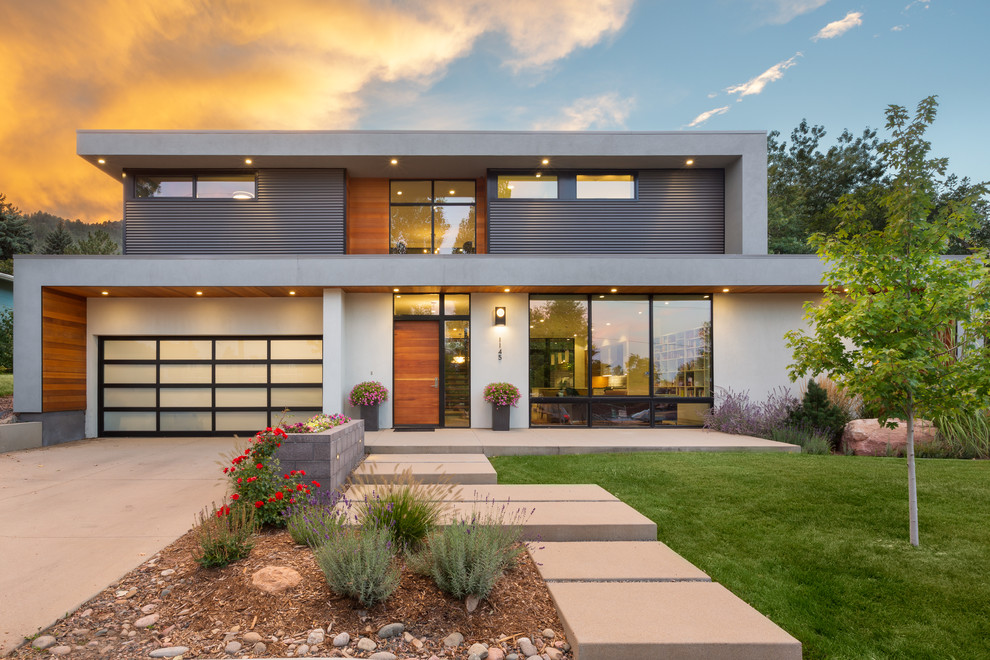 Midcentury two-storey grey house exterior in Denver with mixed siding and a flat roof.