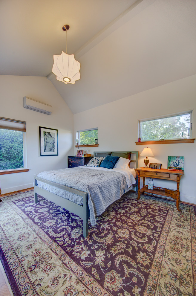 This is an example of a mid-sized transitional guest bedroom in Portland with grey walls, painted wood floors, no fireplace and white floor.