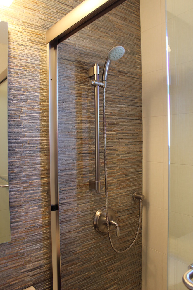 This is an example of a small contemporary bathroom in New York with shaker cabinets, dark wood cabinets, an alcove tub, an alcove shower, a two-piece toilet, slate, porcelain floors, an undermount sink, marble benchtops and a sliding shower screen.