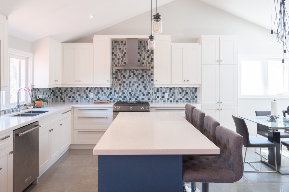 Mid-sized contemporary l-shaped eat-in kitchen in Toronto with a double-bowl sink, shaker cabinets, white cabinets, quartzite benchtops, blue splashback, stainless steel appliances, with island, beige floor and white benchtop.