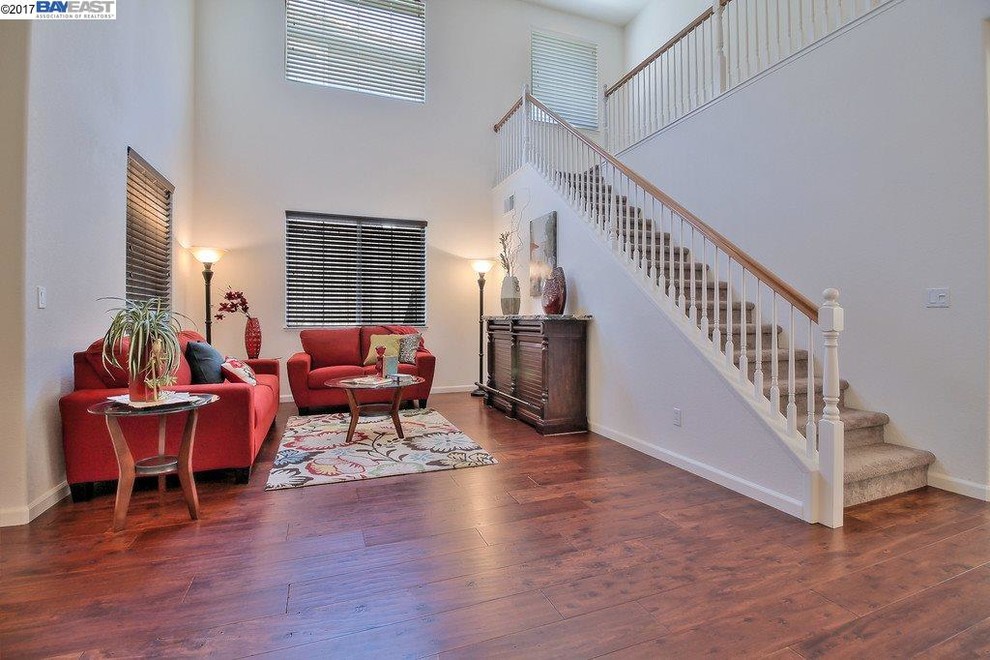 Inspiration for a mid-sized timeless formal and open concept dark wood floor and brown floor living room remodel in Sacramento with white walls and no fireplace