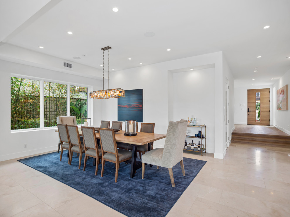 Photo of a large contemporary open plan dining in Orange County with white walls, marble floors and beige floor.