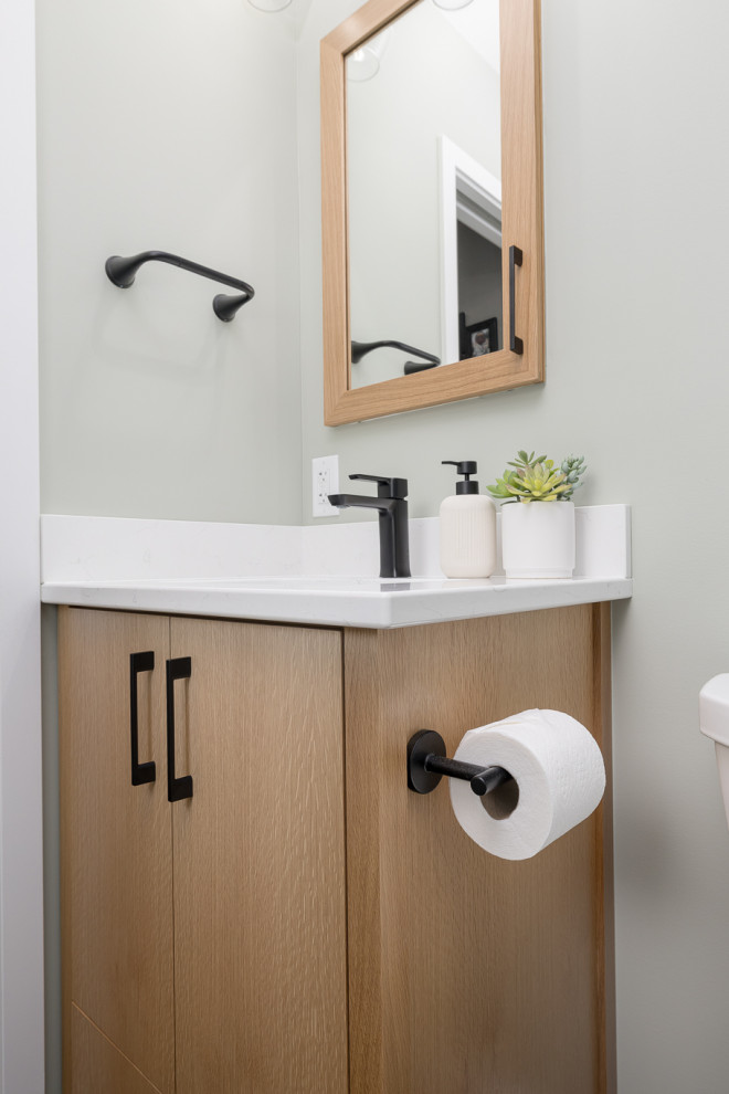 Small traditional ensuite bathroom in Other with flat-panel cabinets, light wood cabinets, an alcove shower, a one-piece toilet, white tiles, ceramic tiles, green walls, porcelain flooring, a submerged sink, engineered stone worktops, black floors, a sliding door, white worktops, a wall niche, a single sink and a built in vanity unit.