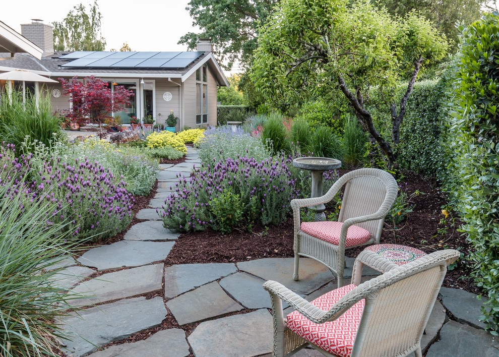 Inspiration for a mediterranean backyard partial sun xeriscape in San Francisco with natural stone pavers.