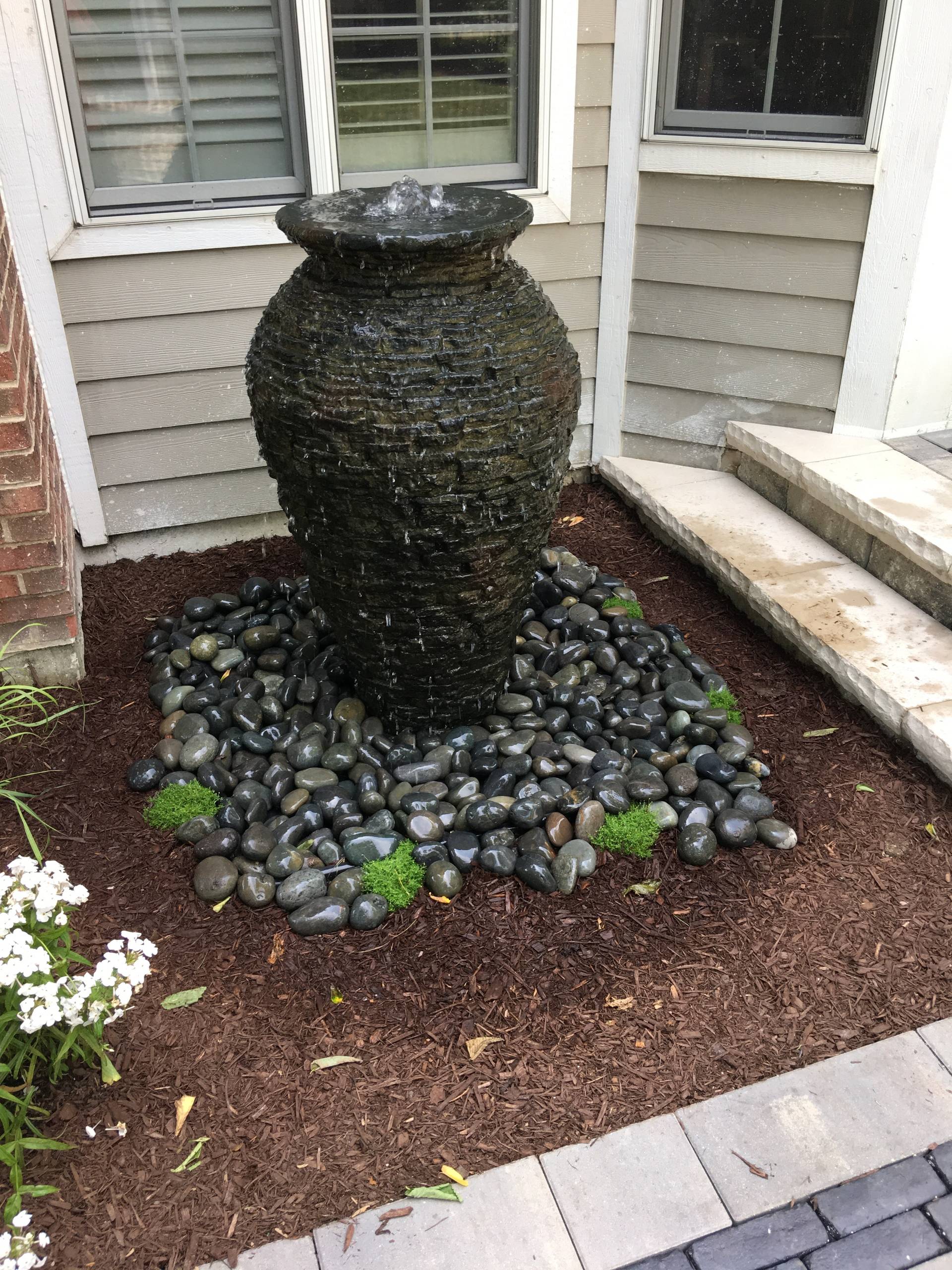 Outdoor Living Space with Gas Fire Pit and Lush Landscapes