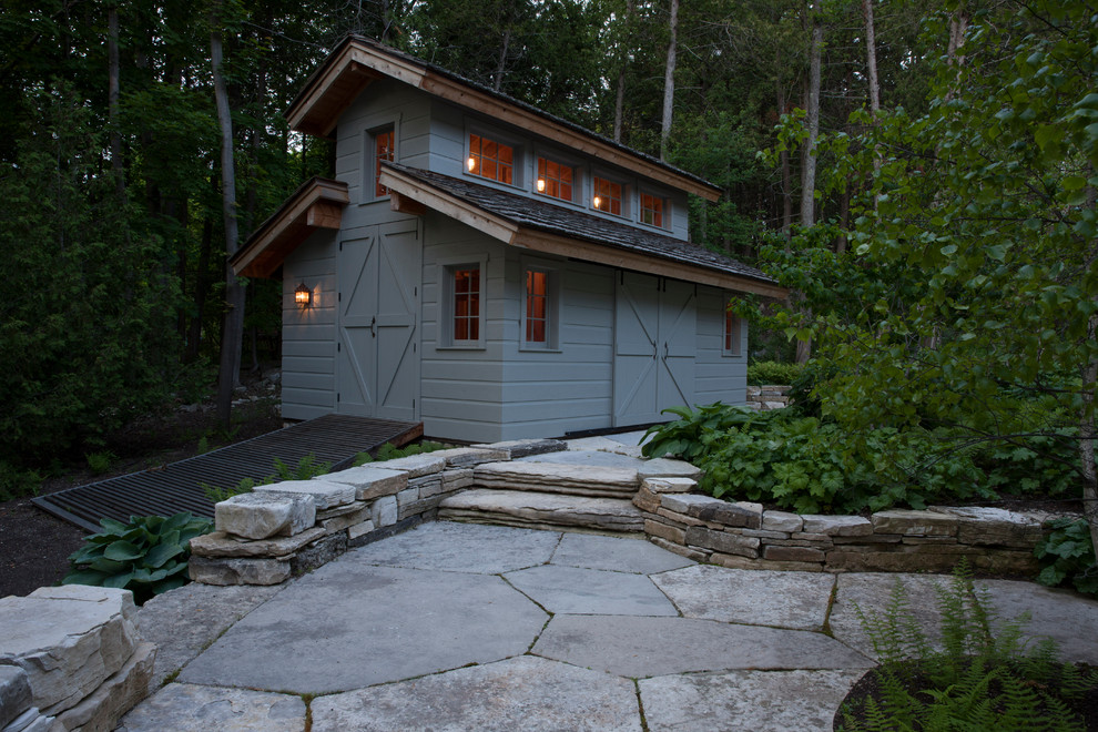 Inspiration for a large rustic partial sun side yard stone landscaping for summer.
