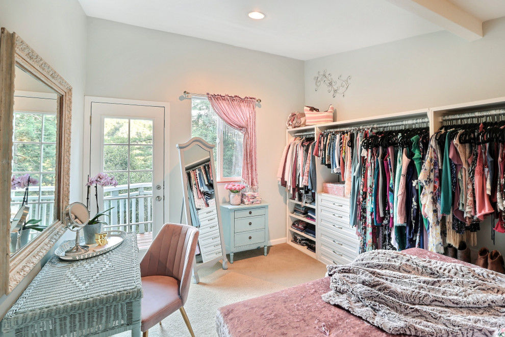 Design ideas for a mid-sized traditional women's dressing room with shaker cabinets, white cabinets, carpet and beige floor.