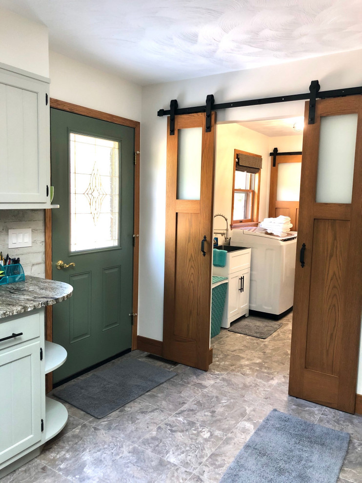Photo of a country laundry room in Other with an utility sink, vinyl floors, a side-by-side washer and dryer and grey floor.