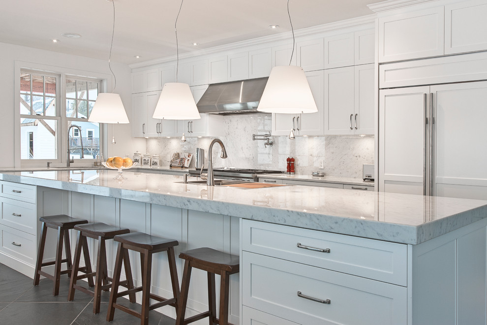 Inspiration for a transitional l-shaped kitchen in Montreal with shaker cabinets, white cabinets, white splashback and panelled appliances.