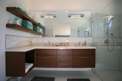 Open shelving in a bathroom is the perfect spot to store a few odds and ends, including rolled towels for that "spa" look. Subway tile in the shower is classic and simple.