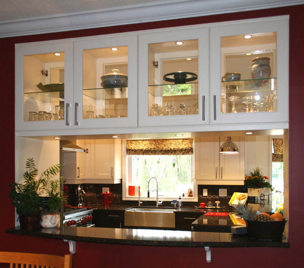 Eat-in kitchen - mid-sized transitional u-shaped porcelain tile eat-in kitchen idea in Toronto with a farmhouse sink, shaker cabinets, dark wood cabinets, quartz countertops, brown backsplash, ceramic backsplash, stainless steel appliances and a peninsula