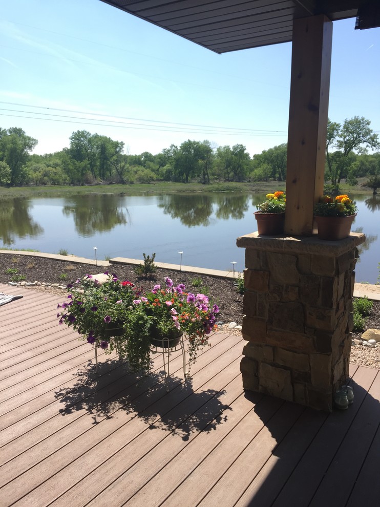 Inspiration for a rustic front yard patio remodel with a roof extension