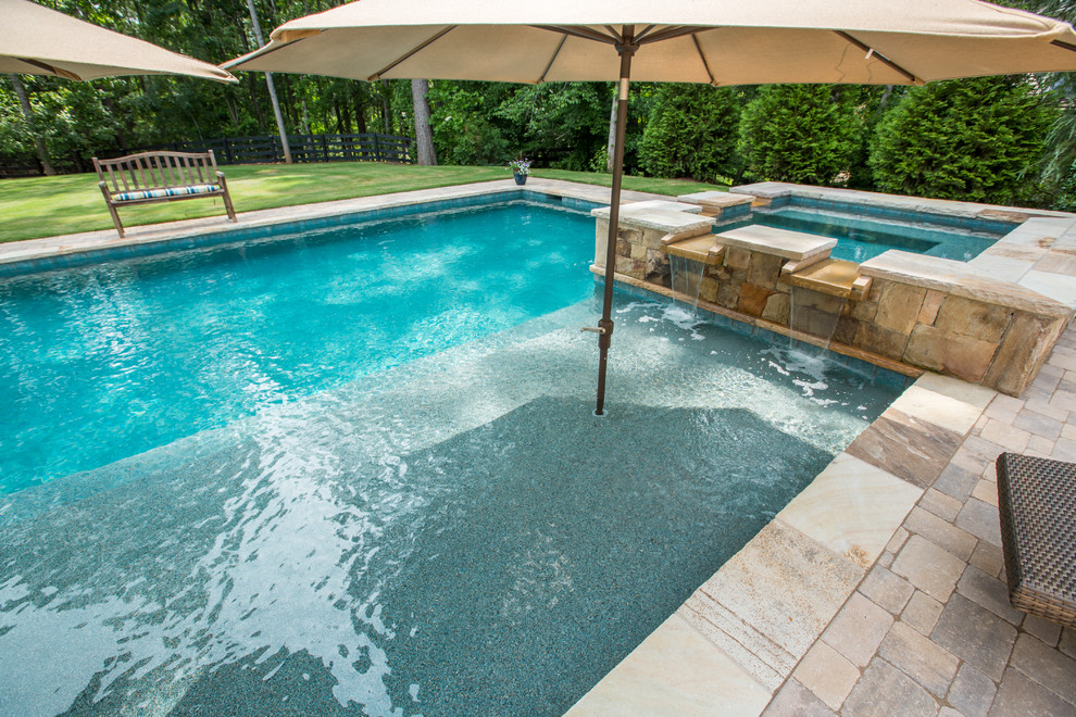 Inspiration for a mid-sized country backyard rectangular natural pool in Atlanta with a hot tub and natural stone pavers.