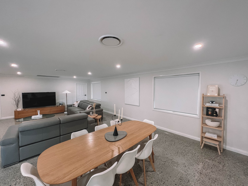 Design ideas for a mid-sized scandinavian open plan dining in Newcastle - Maitland with white walls, concrete floors, grey floor, wood and wood walls.