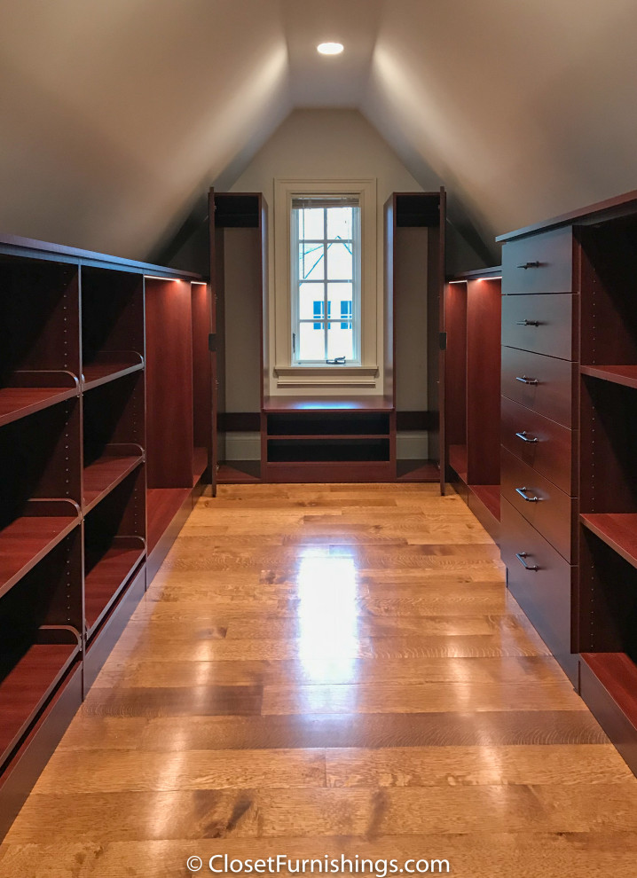 Inspiration for a mid-sized modern gender-neutral walk-in wardrobe in Chicago with flat-panel cabinets, red cabinets and dark hardwood floors.