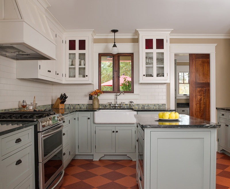 Mid-sized arts and crafts u-shaped separate kitchen in Atlanta with a farmhouse sink, shaker cabinets, grey cabinets, soapstone benchtops, white splashback, subway tile splashback, stainless steel appliances, porcelain floors, with island, multi-coloured floor and black benchtop.