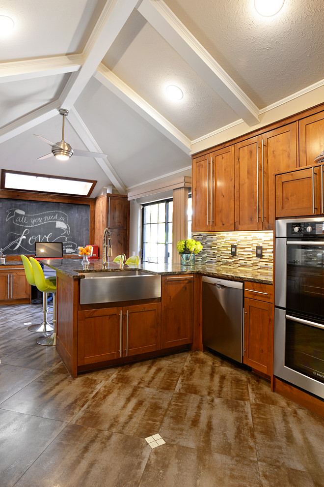 Example of a large transitional u-shaped travertine floor eat-in kitchen design in Dallas with a farmhouse sink, medium tone wood cabinets, granite countertops, multicolored backsplash, matchstick tile backsplash, stainless steel appliances and a peninsula