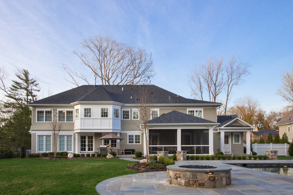 Inspiration for a transitional full sun backyard stone landscaping in DC Metro with a fire pit.