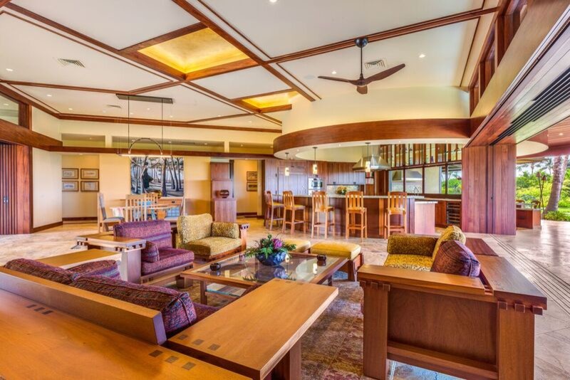 Expansive arts and crafts formal open concept living room in Hawaii with yellow walls, travertine floors and a concealed tv.