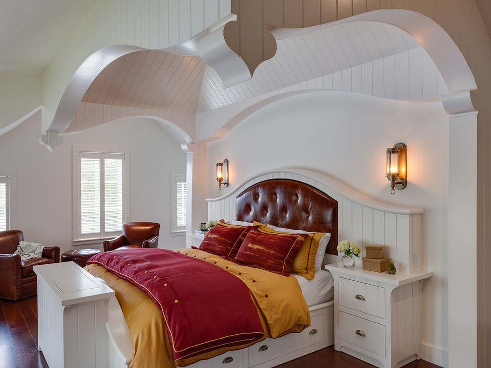 Photo of a mid-sized beach style master bedroom in Boston with white walls, dark hardwood floors and brown floor.