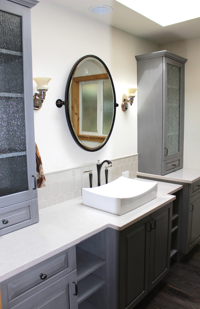 Inspiration for a large transitional master bathroom in Seattle with a trough sink, raised-panel cabinets, grey cabinets, engineered quartz benchtops, gray tile, ceramic tile, white walls, dark hardwood floors and white benchtops.