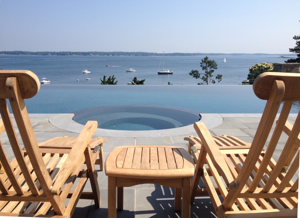 Transitional hillside stone infinity pool photo in Boston