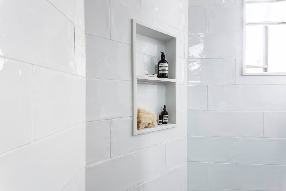 Design ideas for a small eclectic 3/4 bathroom in Montreal with flat-panel cabinets, medium wood cabinets, an open shower, white tile, ceramic tile, porcelain floors, an integrated sink, black floor, an open shower, white benchtops, white walls and engineered quartz benchtops.