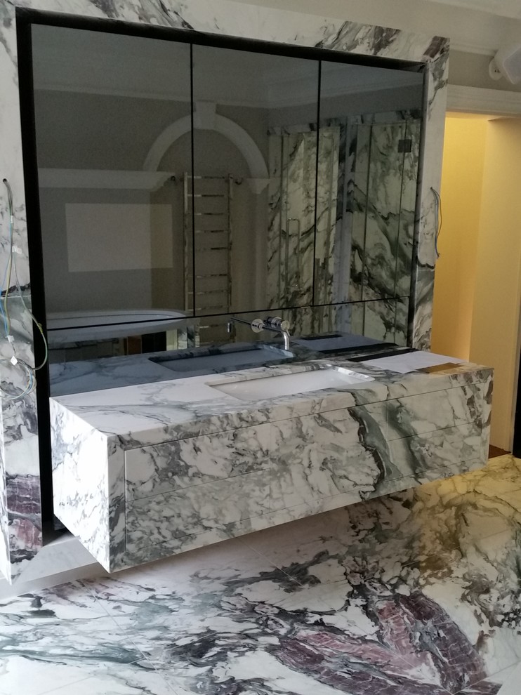 Photo of a contemporary bathroom in London with marble floors.