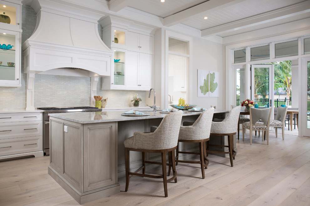 Light wood floor open concept kitchen photo with stainless steel appliances and an island