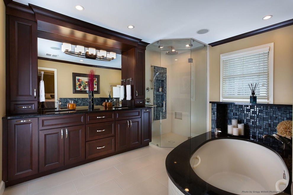 Inspiration for a mid-sized contemporary master bathroom in Atlanta with flat-panel cabinets, slate, beige walls, an undermount sink, an undermount tub, dark wood cabinets, porcelain floors, granite benchtops, beige floor, a hinged shower door, a curbless shower and a one-piece toilet.