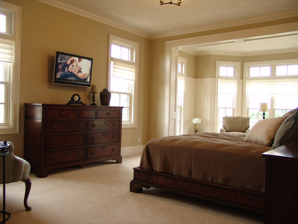 Large traditional master bedroom in Other with carpet.