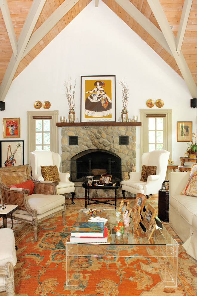 Inspiration for a mid-sized eclectic formal enclosed living room in Boston with white walls, a standard fireplace, a stone fireplace surround, medium hardwood floors, no tv and beige floor.