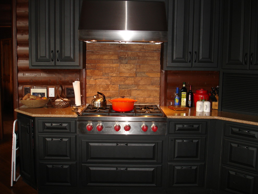 Mid-sized mountain style single-wall medium tone wood floor and beige floor enclosed kitchen photo with raised-panel cabinets, black cabinets, granite countertops, beige backsplash, wood backsplash, stainless steel appliances and no island
