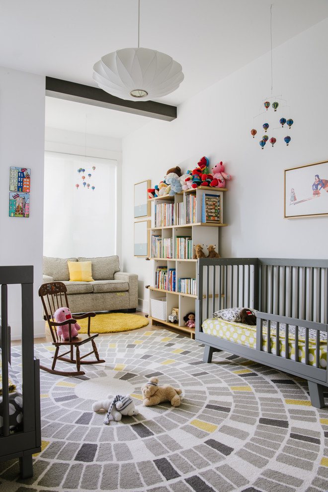 Mid-sized contemporary gender-neutral nursery in DC Metro with white walls, carpet and multi-coloured floor.